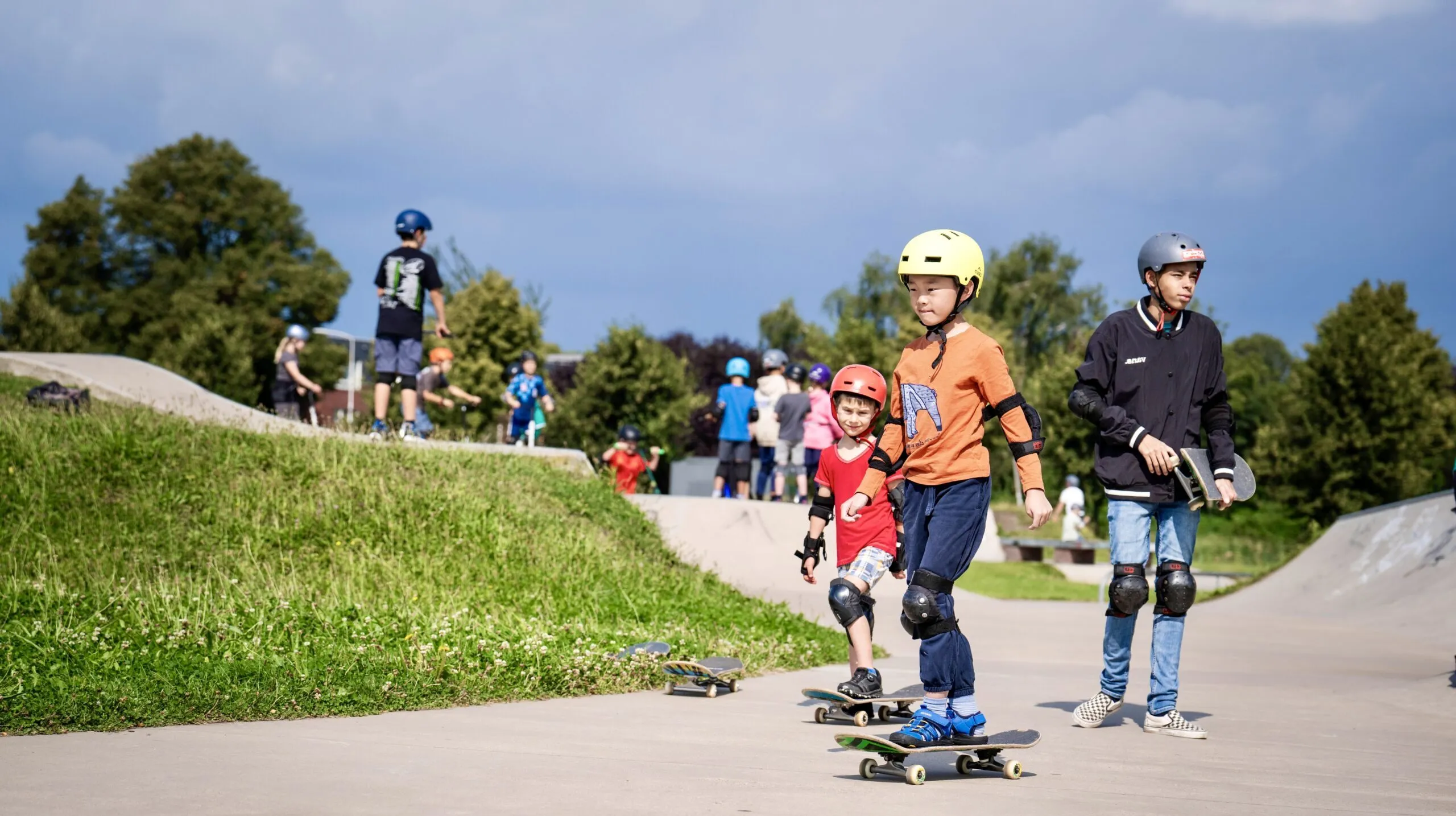 Kinderen die op de skatebaan aan het skateboarden zijn